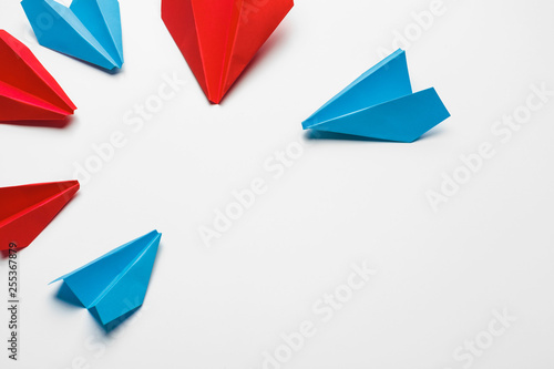 Red and blue paper planes on white background. Leadership and Business competition concepts