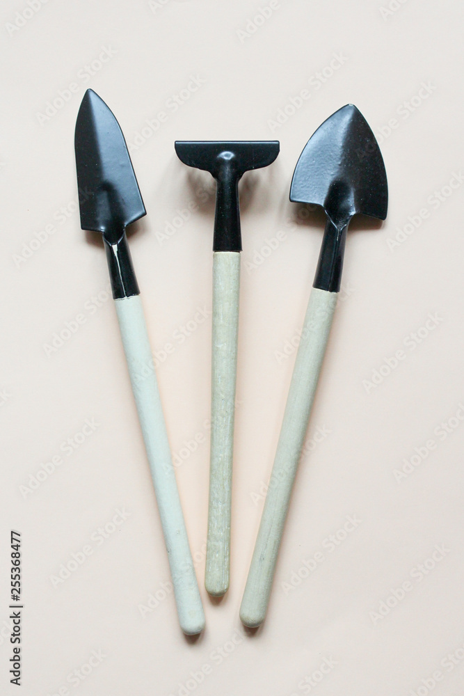 set of three garden tools on light cream background set of three garden tools on light cream background