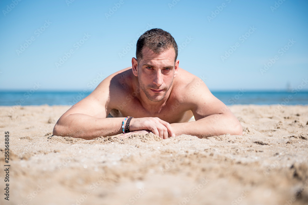 Attractive man posing on the beach Attractive man posing on the beach