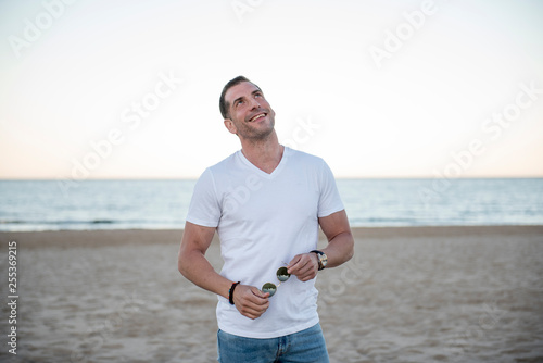 Attractive man posing on the beach