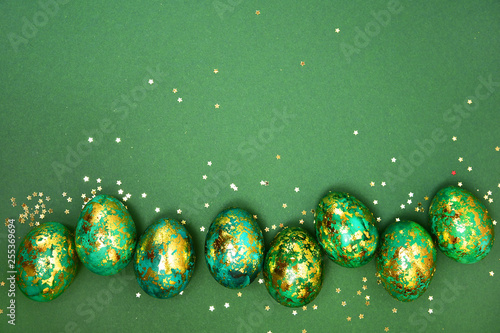 Wall Mural Easter eggs, dark green with gold on a green background
