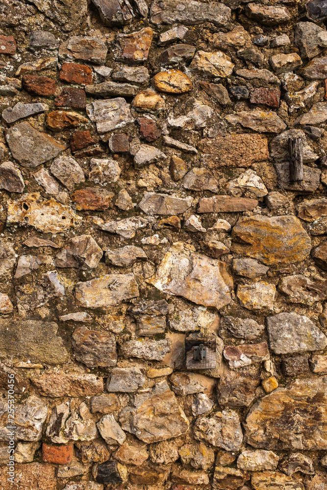 A wall made of large rocks and cement, great for a background or wallpaper