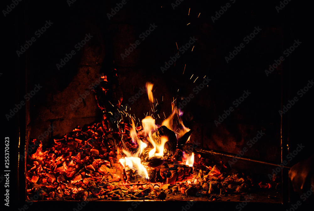A glowing fire in the stone fireplace A glowing fire in the stone fireplace