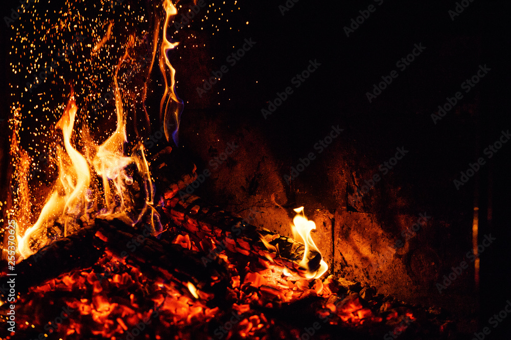 A glowing fire in the stone fireplace A glowing fire in the stone fireplace