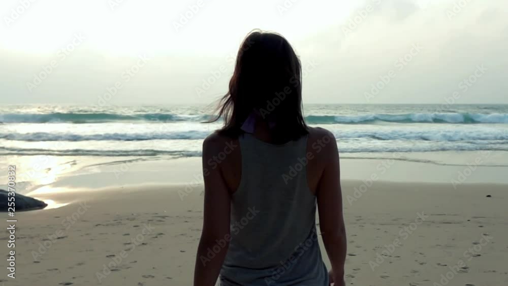 Beautiful woman walking along beach, super slow motion Beautiful woman walking along beach, super slow motion
