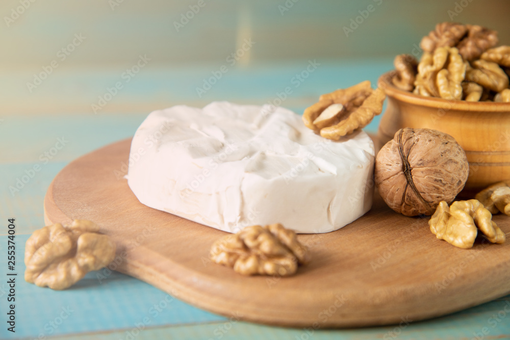 Cheese camembert or brie with walnut kernels Cheese camembert or brie with walnut kernels