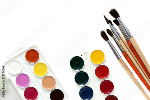 Watercolor paints and brushes isolated on white background close up