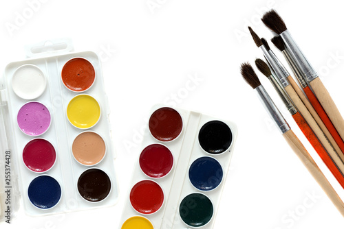 Watercolor paints and brushes isolated on white background close up