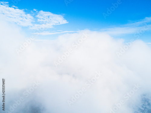 Aerial view White clouds in blue sky. Top view. View from drone. Aerial bird's eye view. Aerial top view cloudscape. Texture of clouds. View from above.