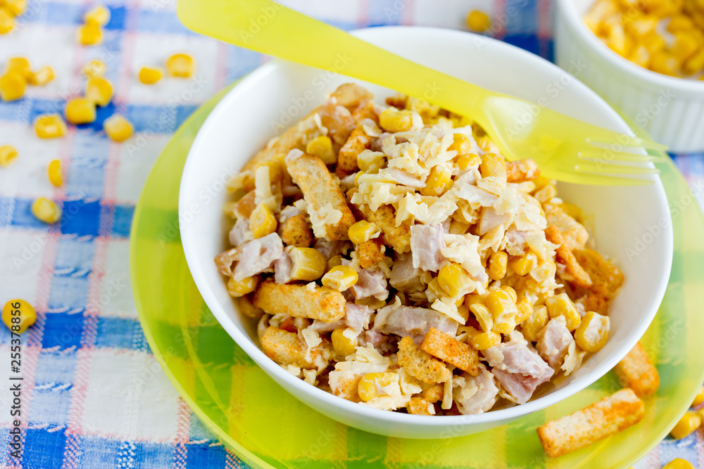 Mixed salad from ham, cheese, boiled egg, canned corn and bread crusts with mayonnaise dressing for Easter dinner Mixed salad from ham, cheese, boiled egg, canned corn and bread crusts with mayonnaise dressing for Easter dinner