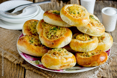 Homemade dinner buns stuffed with minced meat and cheese. Round meat patties from yeast dough for snack. Cheese meat pizza pies