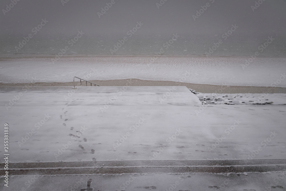 Footsteps in the snow at Vlissingen beach Netherlands Footsteps in the snow at Vlissingen beach Netherlands