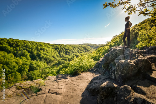 Beautiful girl hiker enjoys view over Soderasen Skaralid valley Sweden