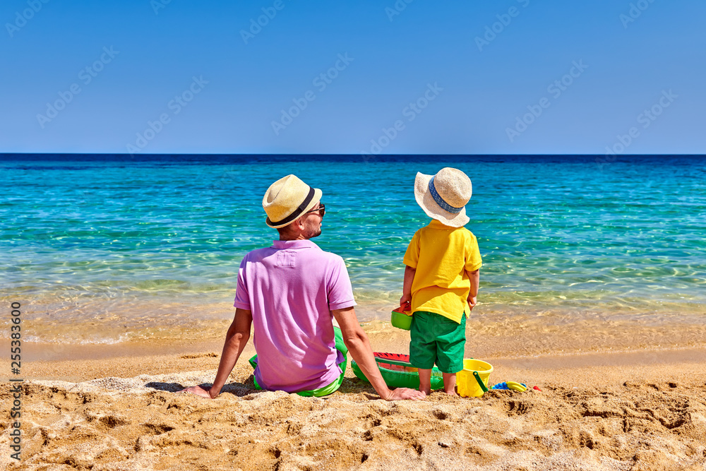 Toddler boy on beach with father Toddler boy on beach with father