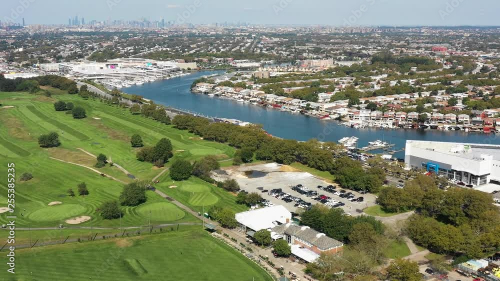 aerial view of golf course, marina, city and ocean 4k aerial view of golf course, marina, city and ocean 4k