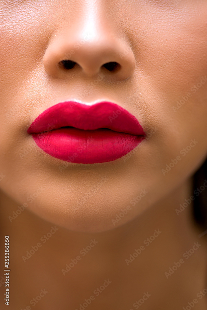 Obraz premium Close-up of red lips of woman with bright lipstick