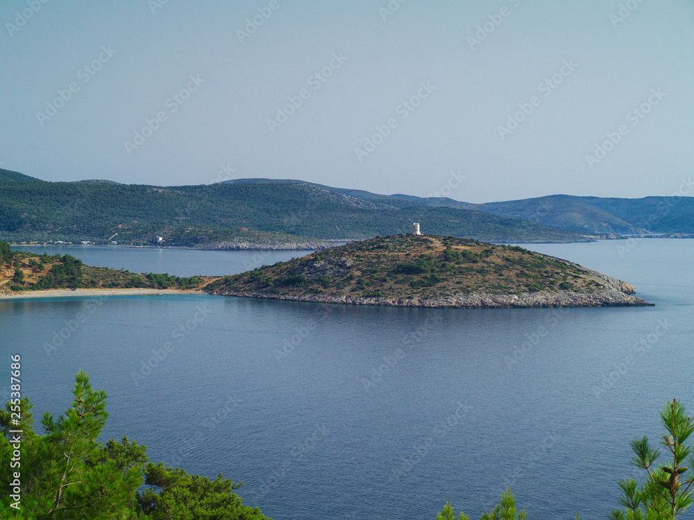 View from above, cape with stone watchtower in Chios island Greece. Fortified medieval cylindrical tower above sea.