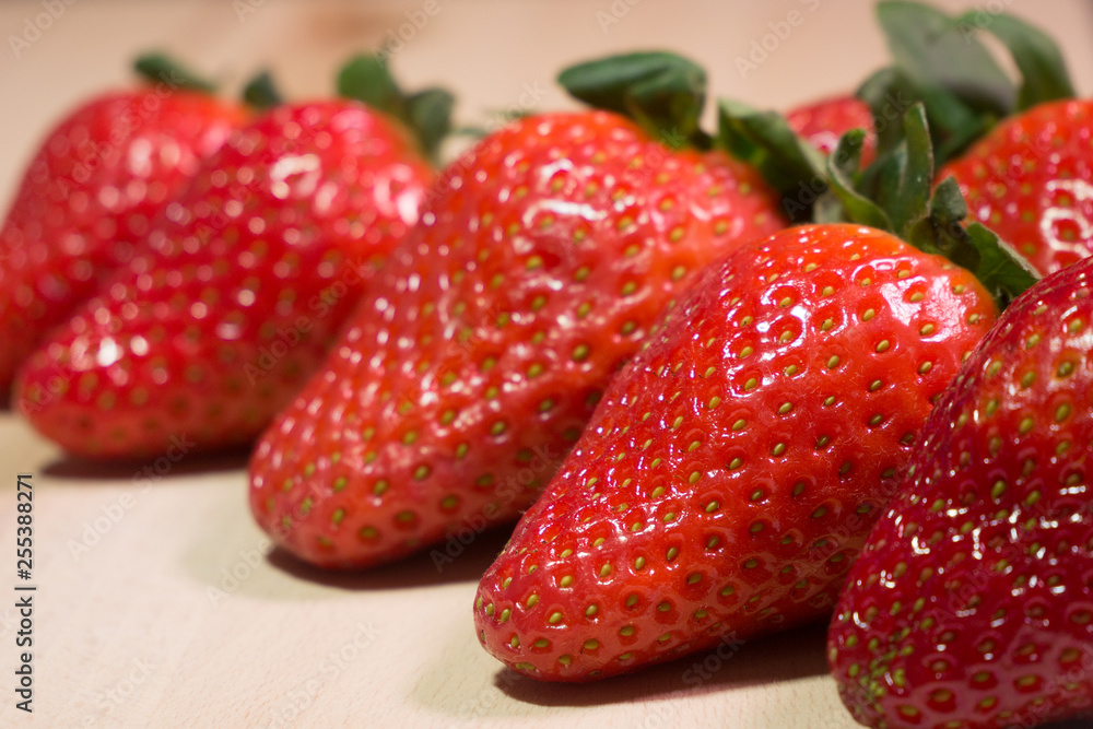 Group of fresh red strawberries on wooden table. Close up. Group of fresh red strawberries on wooden table. Close up.