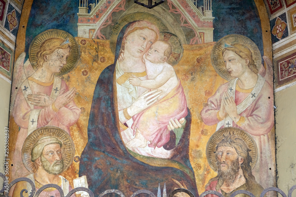 Virgin Mary with baby Jesus, fresco on the house facade in Florence, Italy