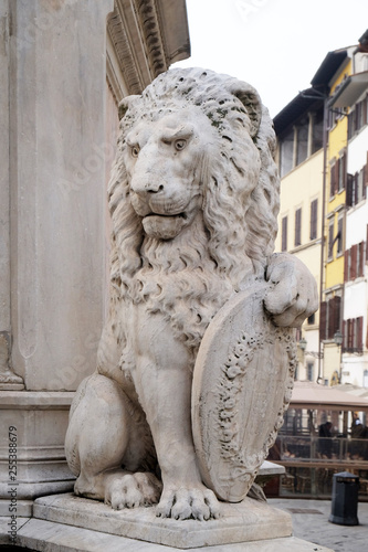 Stone lion holding shield outside of the of Basilica of Santa Croce (Basilica of the Holy Cross) in Florence, Italy