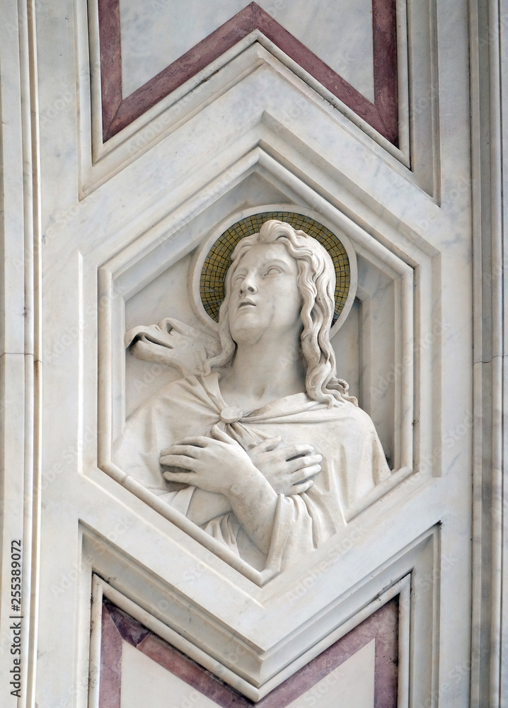 Saint John the Evangelist, relief on the facade of Basilica of Santa Croce (Basilica of the Holy Cross) - famous Franciscan church in Florence, Italy
