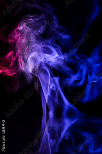 Abstract backgrounds and wallpapers. Colorful smoke on black background..