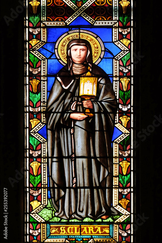 Saint Clare of Assisi, stained glass window in the Basilica di Santa Croce (Basilica of the Holy Cross) in Florence, Italy photo