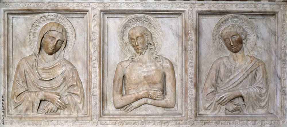 Marble sarcophagus in the Baroncelli Tomb, Florence, sculpted with bas-reliefs with a representation of the Pieta in the Basilica of Santa Croce in Florence, Italy