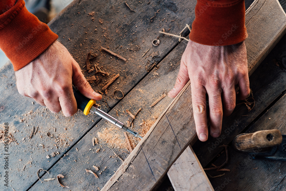 tightening screw with a screwdriver in the wooden bar, making furniture tightening screw with a screwdriver in the wooden bar, making furniture