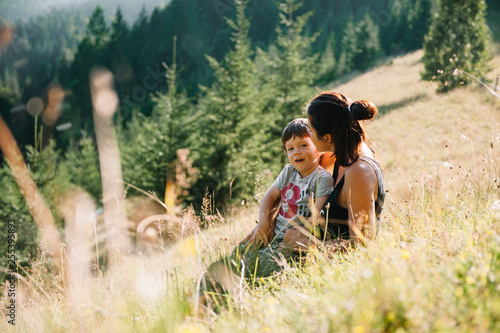 Young mom with baby boy travelling. Mother on hiking adventure with child, family trip in mountains. National Park. Hike with children. Active summer holidays. Fisheye lens photo