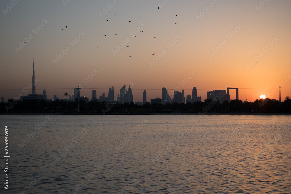 View of the Dubai cityscape at sunset from the Dubai Creek golf & yacht club