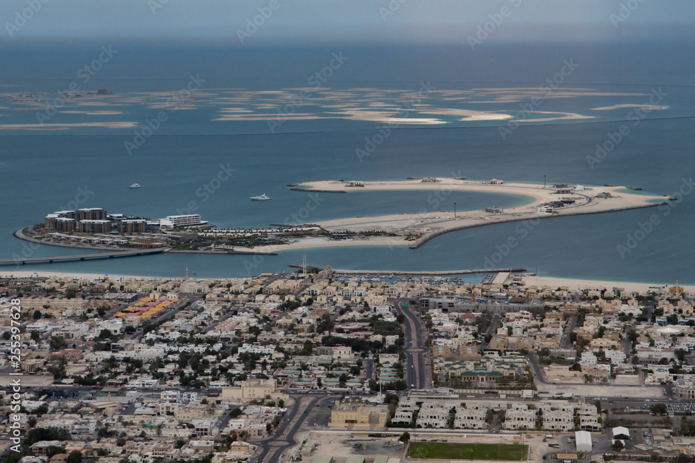 Spectacular aerial of the suburbs of Dubai and the man made islands in the Persian gulf