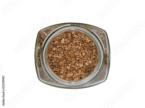 Glass jar filled with instant, granulated coffee the top view on a white background