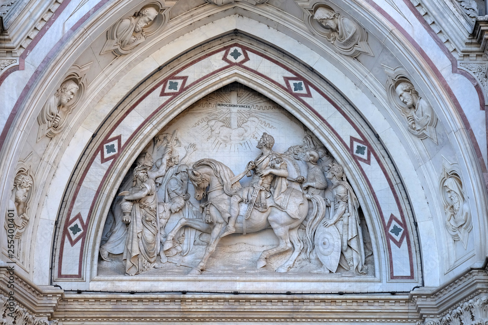 Sculpted lunette containing a scene depicting the Vision of Constantine, by Emilio Zocchi, over the right door of Basilica of Santa Croce in Florence, Italy