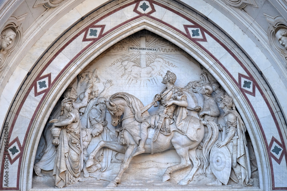 Sculpted lunette containing a scene depicting the Vision of Constantine, by Emilio Zocchi, over the right door of Basilica of Santa Croce in Florence, Italy