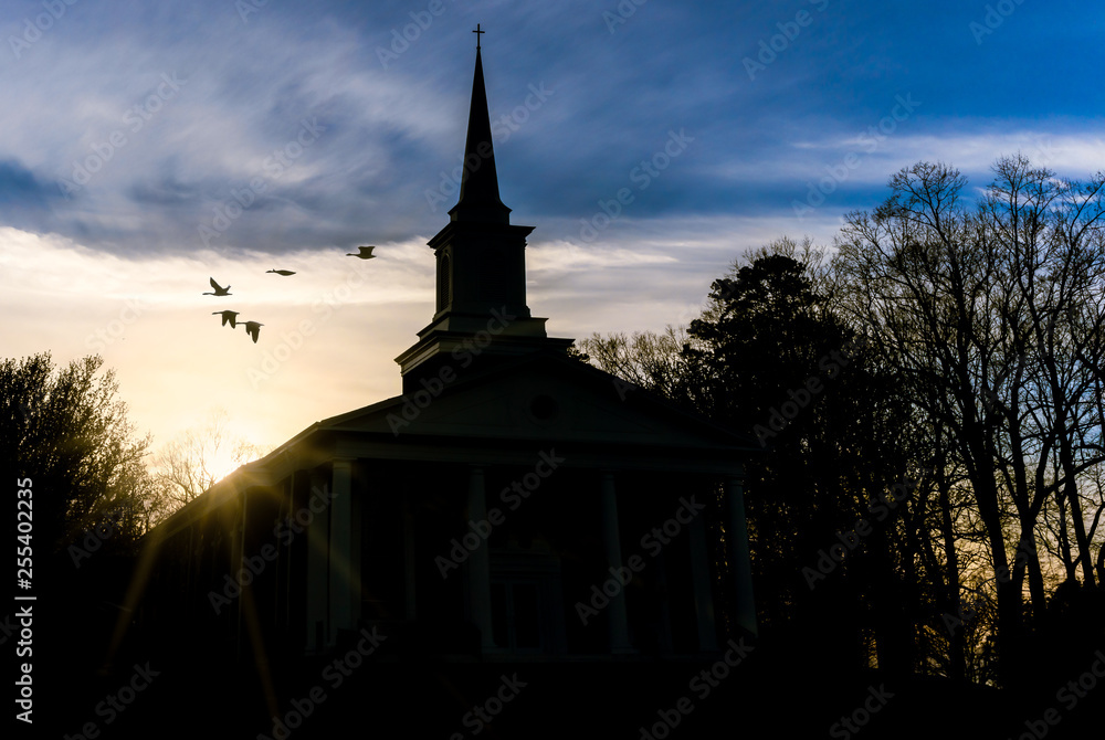 Obraz premium Sunset At Church As Birds Fly
