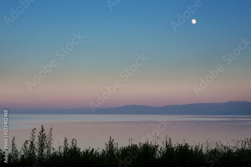 Quiet sunset. Summer calm evening. Full moon.