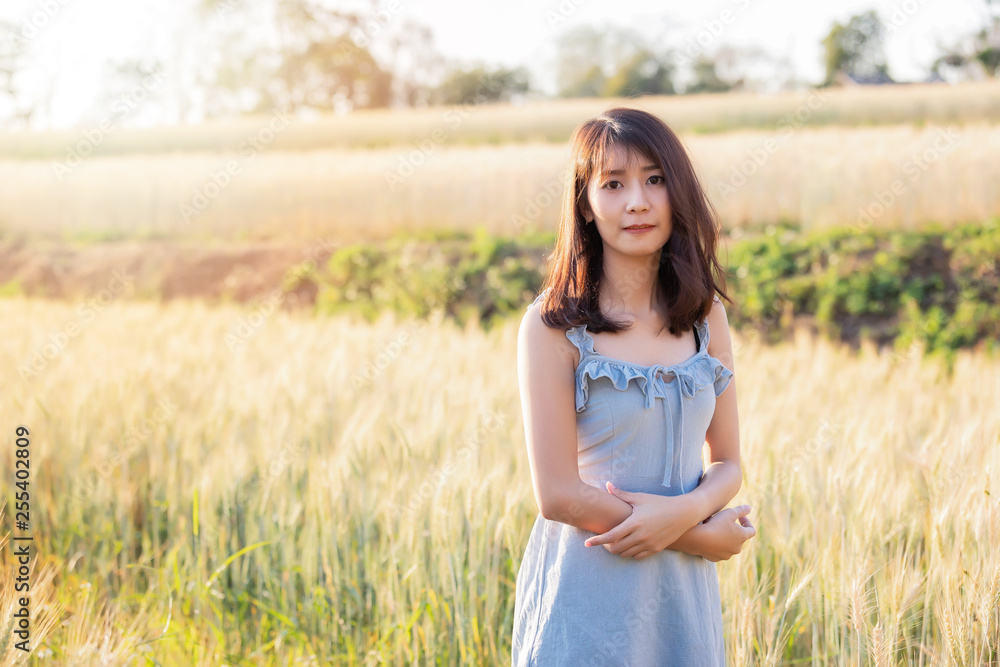 Beautiful and happy asian woman enjoying life in barley field at sunset. Beautiful and happy asian woman enjoying life in barley field at sunset.