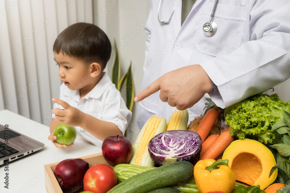 Children and doctors happy to have healthy food.Kid learning about nutrition with doctor to choose eating fresh fruits and vegetables. Children and doctors happy to have healthy food.Kid learning about nutrition with doctor to choose eating fresh fruits and vegetables.