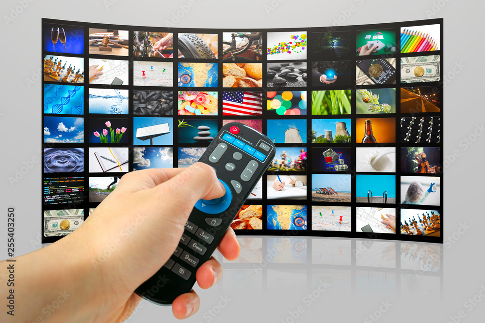TV with pictures of smart television and man's hands with remote control,close up. TV with pictures of smart television and man's hands with remote control,close up.
