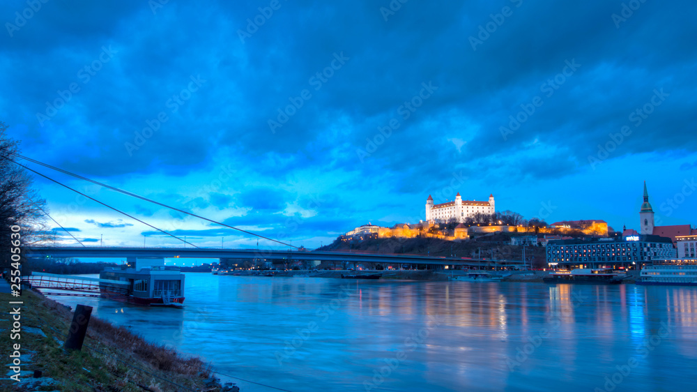 night view of Bratislava castle from river surface with dramtic sunset skyline