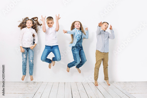 Kids boys and girls merry happy beautiful on white wall background