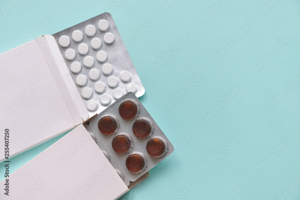 pills medication pills in white paper boxes on an isolated blue background. Doctors and formatsevtsy to cure health in the hospital. angular composition, close-up pills medication pills in white paper boxes on an isolated blue background. Doctors and formatsevtsy to cure health in the hospital. angular composition, close-up