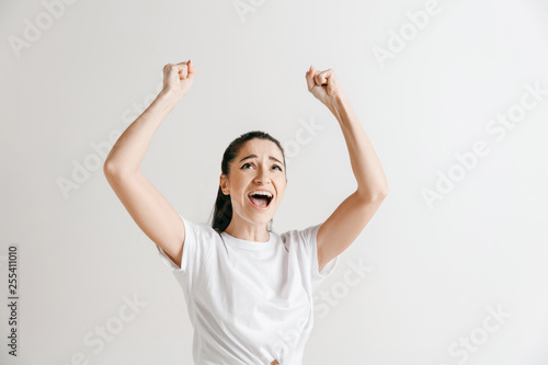 I won. Winning success happy woman celebrating being a winner. Dynamic image of female model on gray studio background. Victory, delight concept. Human facial emotions concept.