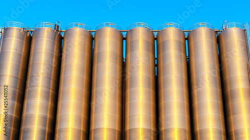 Chemical plant  containers . Storage tanks for petroleum products. Equipment refinery . White tanks for petrol and oil in tank farm with blue sky .