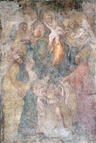 Virgin Mary with baby Jesus and Saints fresco on Palazzo Pretorio or Palazzo del Podesta in Lucca, Tuscany, Italy 