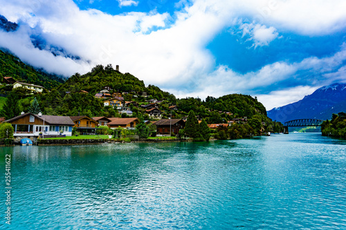 Natural landscape of clear blue lake with mountains and villages in cloudy day