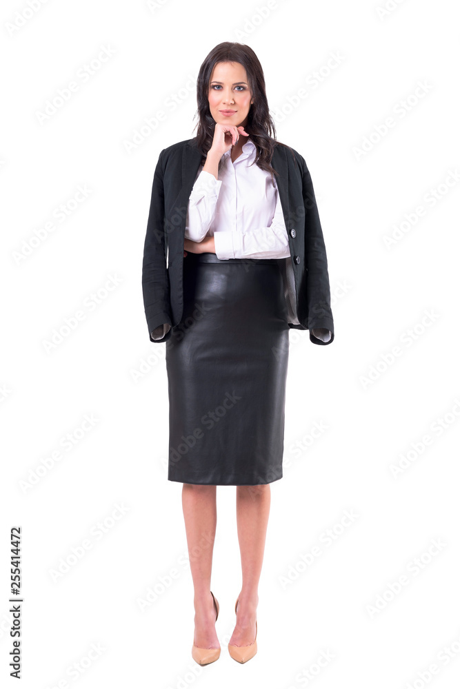Interested beautiful young business woman with hand on chin watching and looking at camera. Full body isolated on white background. Interested beautiful young business woman with hand on chin watching and looking at camera. Full body isolated on white background.