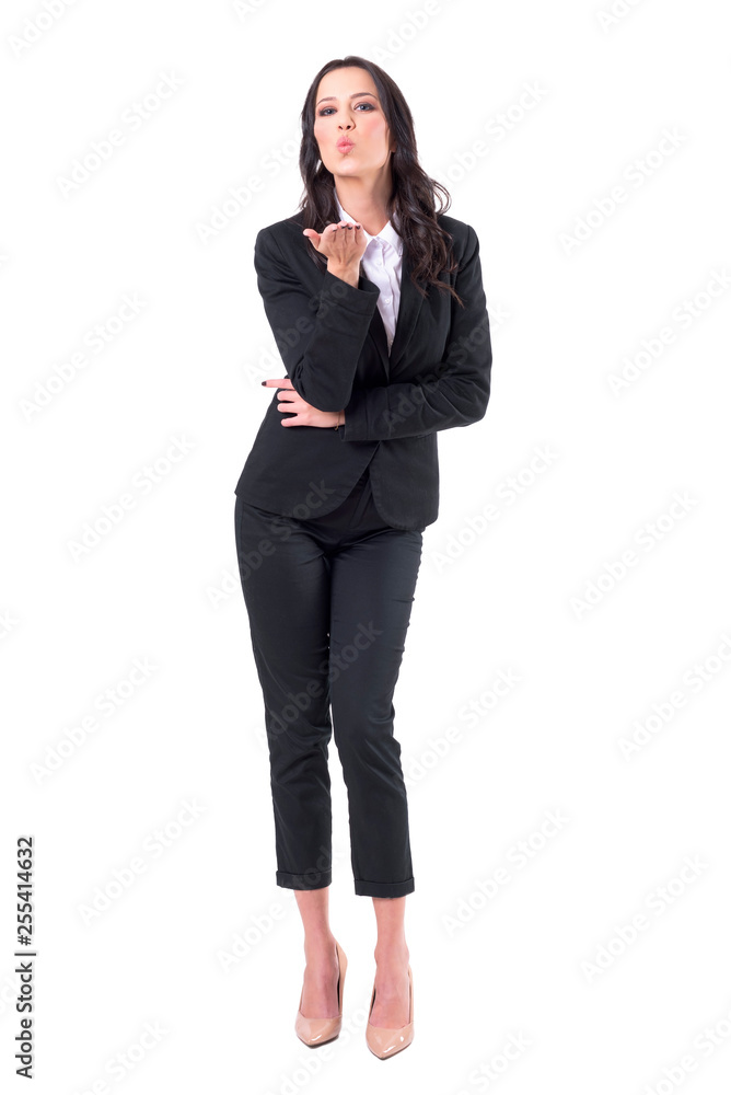 Flirty charming business woman in elegant suit blowing air kiss at camera. Full body isolated on white background. Flirty charming business woman in elegant suit blowing air kiss at camera. Full body isolated on white background.