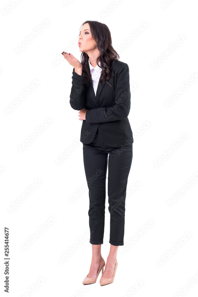 Charming elegant business woman sending and blowing air kiss looking away. Full body isolated on white background. Charming elegant business woman sending and blowing air kiss looking away. Full body isolated on white background.